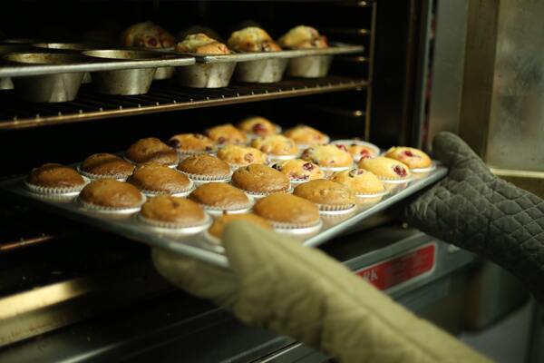 Place muffins in the oven (best baking classes singapore)