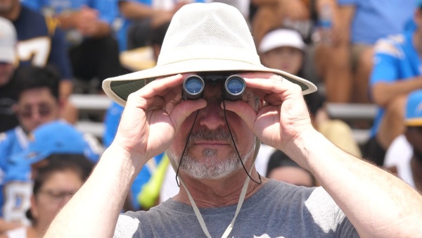 best binoculars singapore man using binoculars