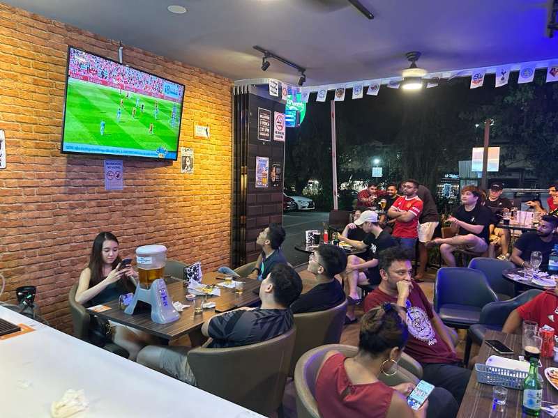 Sports bar filled with people watching football in Singapore