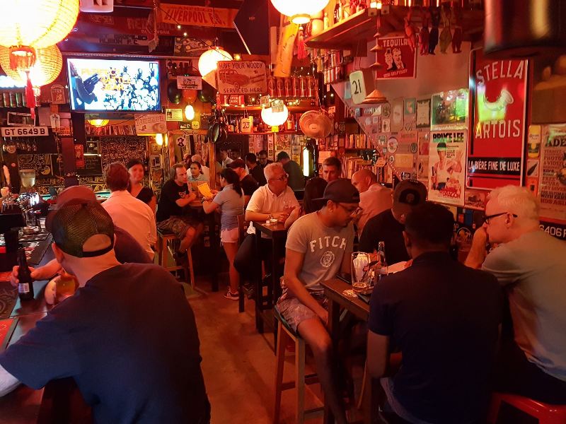 Sports bar in Singapore filled with people watching football.