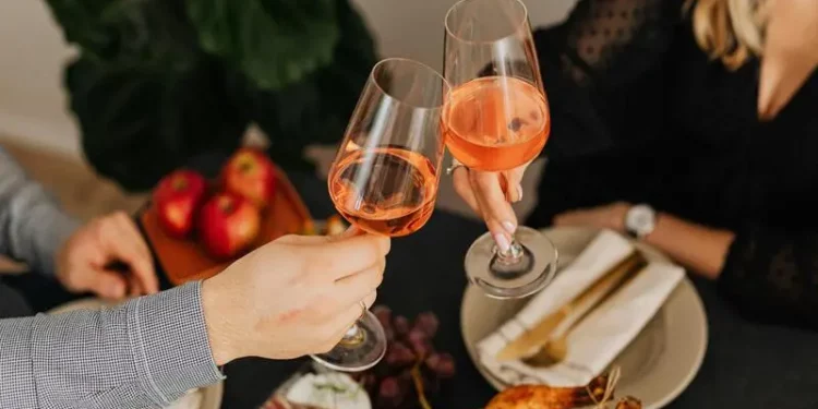 Dine at these affordable romantic restaurants in Singapore, man and woman clinking glasses with wine during dinner