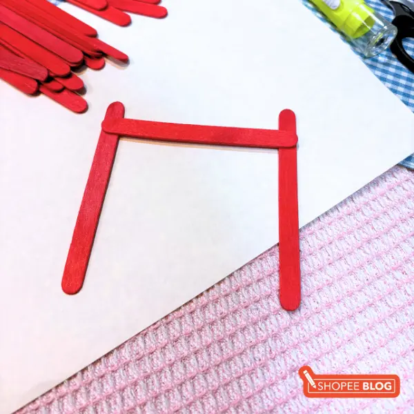 diy lantern craft - aligning red popsicle sticks