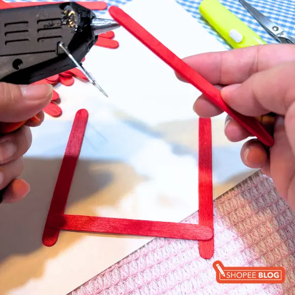 diy lantern craft - securing lantern frame with hot glue