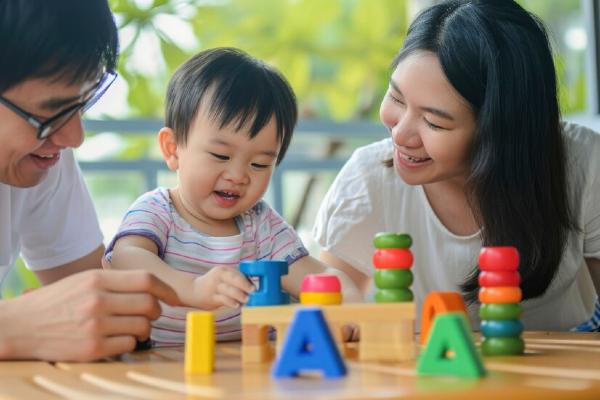 baby classes singapore parents teaching infant to use building blocks