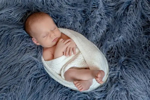 newborn baby swaddled in a blanket best newborn photoshoot singapore