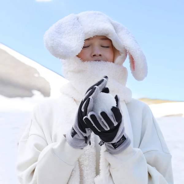 woman wearing beanie and gloves: winter packing list essentials