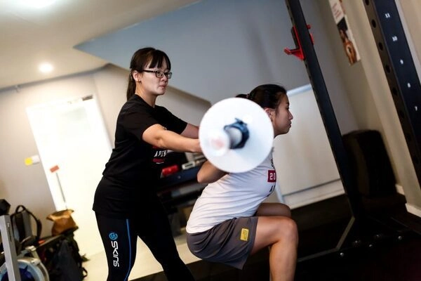 client doing a deep squat at Strength Avenue