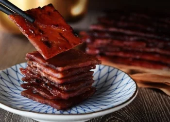 savouring the best bak kwa in singapore with a pair of chopsticks