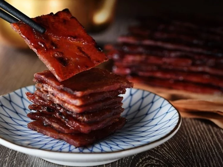 savouring the best bak kwa in singapore with a pair of chopsticks