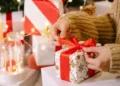 women unwrapping her christmas gift