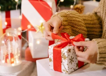 women unwrapping her christmas gift