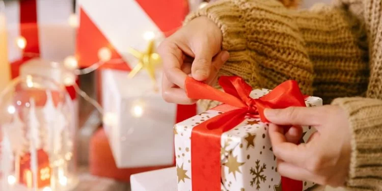 women unwrapping her christmas gift