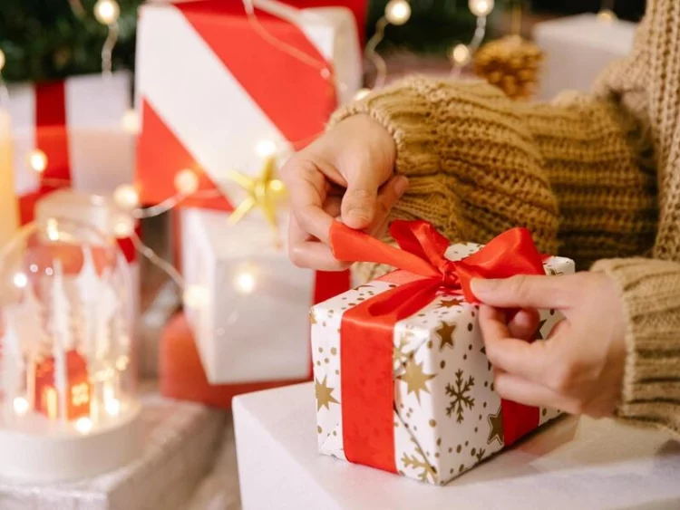 women unwrapping her christmas gift