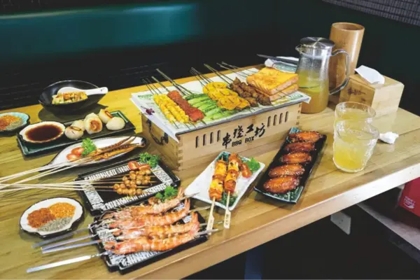 bugis food: BBQ skewers served on a grill stove