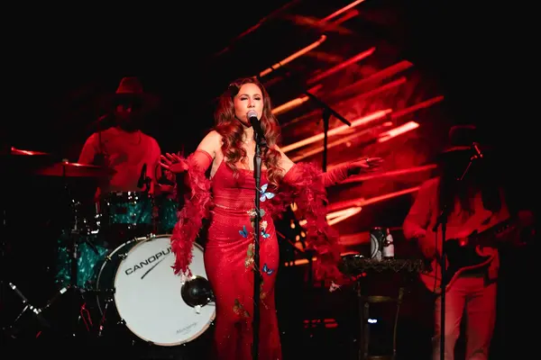 Haley Reinhart singing on stage with live band